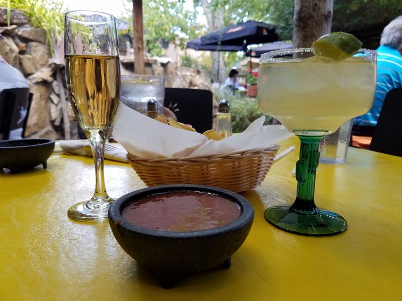 A bowl of chips and salsa with a flute of proscecco and a margarita at the Church Street Cafe in Albuquerque NM